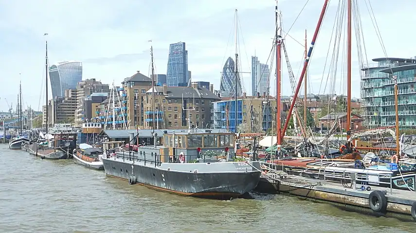 Moored-up boats with the City of London behind