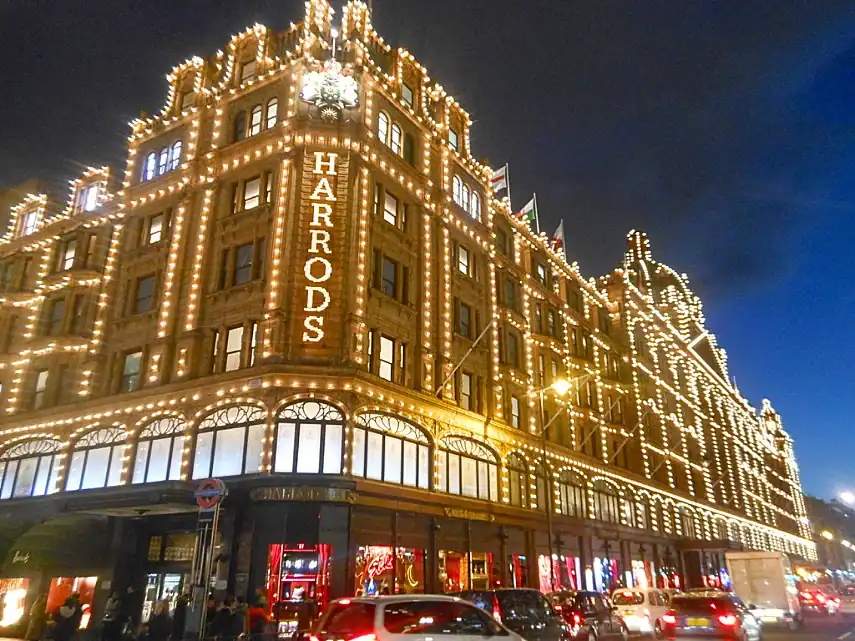 Front of Harrods illuminated with golden bulbs