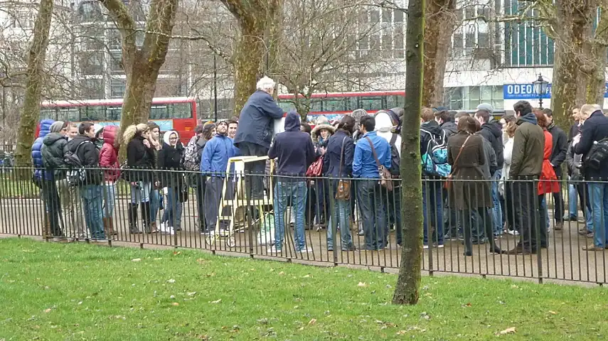 One of the public speakers standing on a stepladder